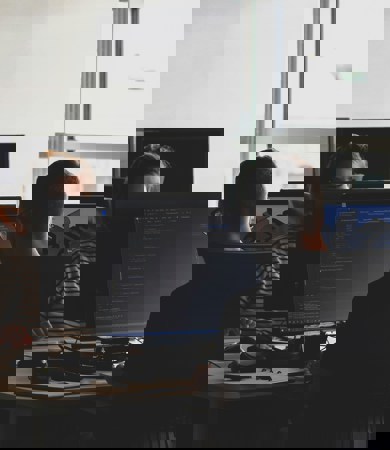 Three people working on software in the office